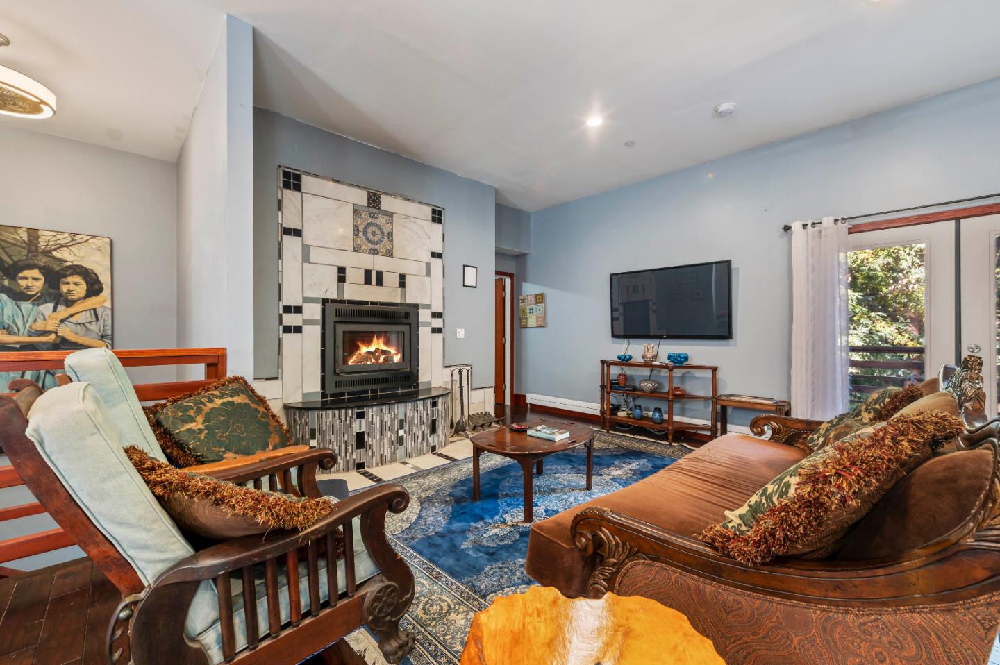 381 Hopkins Gulch Road Boulder Creek, CA 95006 - Photo 11 of 44 a living room with furniture flat screen tv and a fireplace