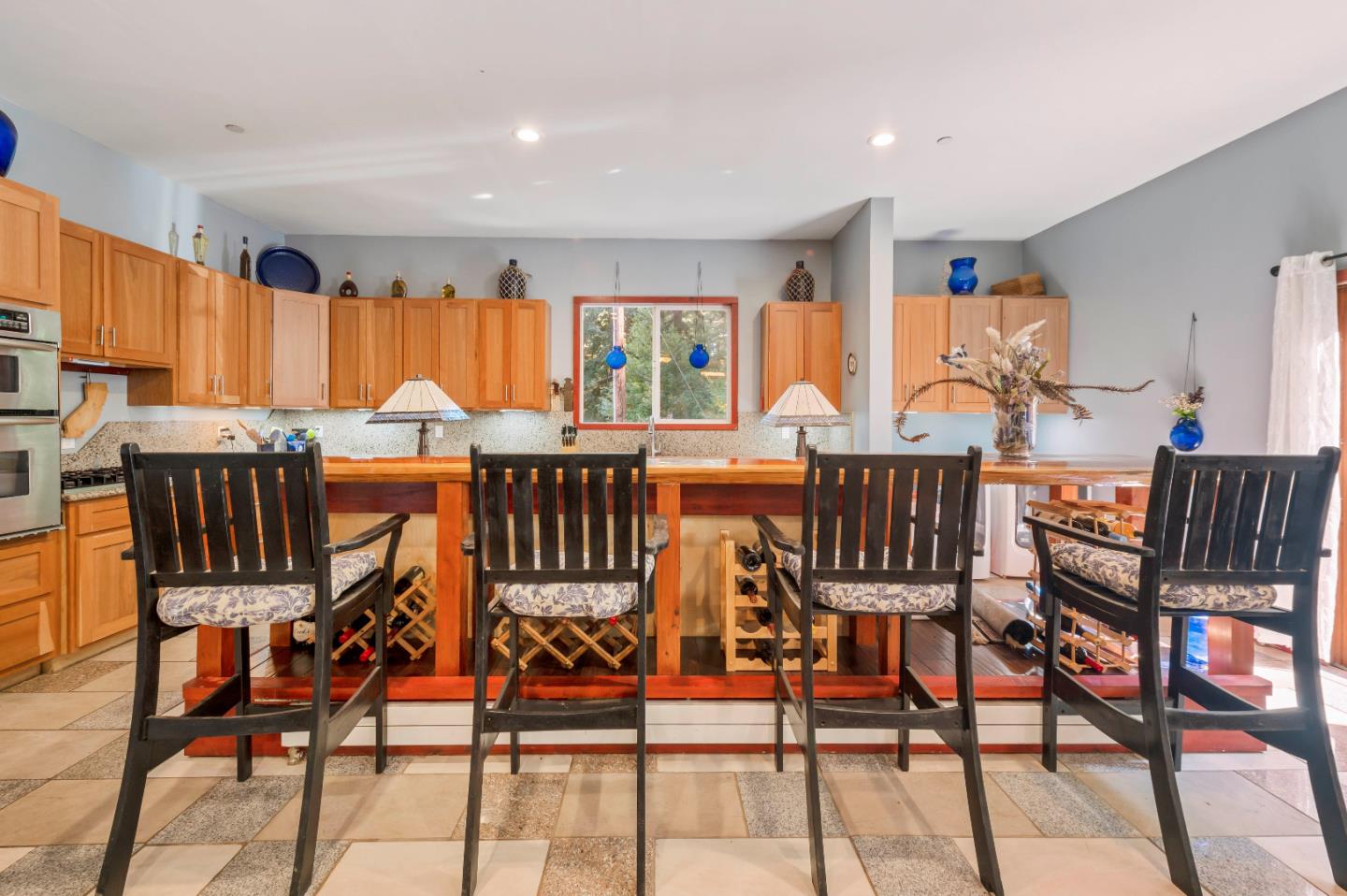 381 Hopkins Gulch Road Boulder Creek, CA 95006 - Photo 13 of 44 a view of a dining room with furniture and a large window