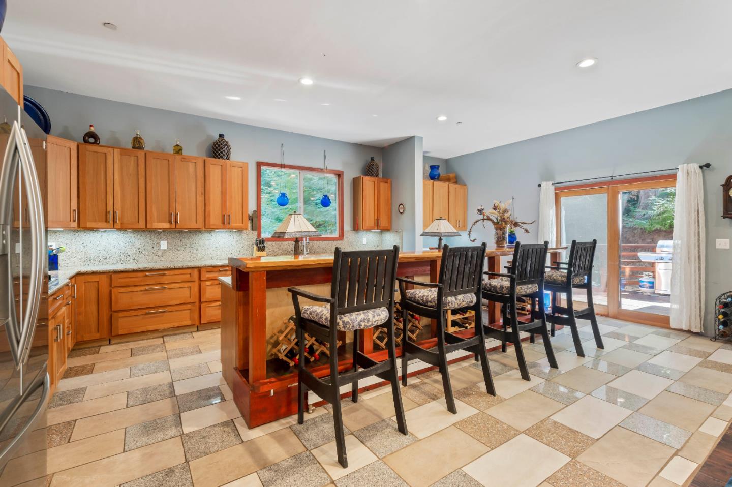 381 Hopkins Gulch Road Boulder Creek, CA 95006 - Photo 14 of 44 a kitchen with stainless steel appliances granite countertop a table and chairs in it