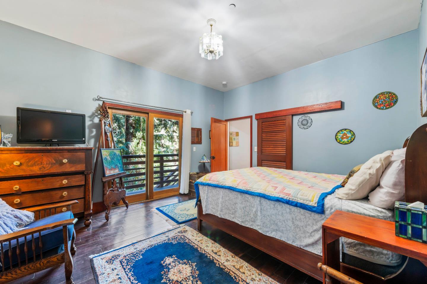 381 Hopkins Gulch Road Boulder Creek, CA 95006 - Photo 20 of 44 a bedroom with a bed and a flat screen tv