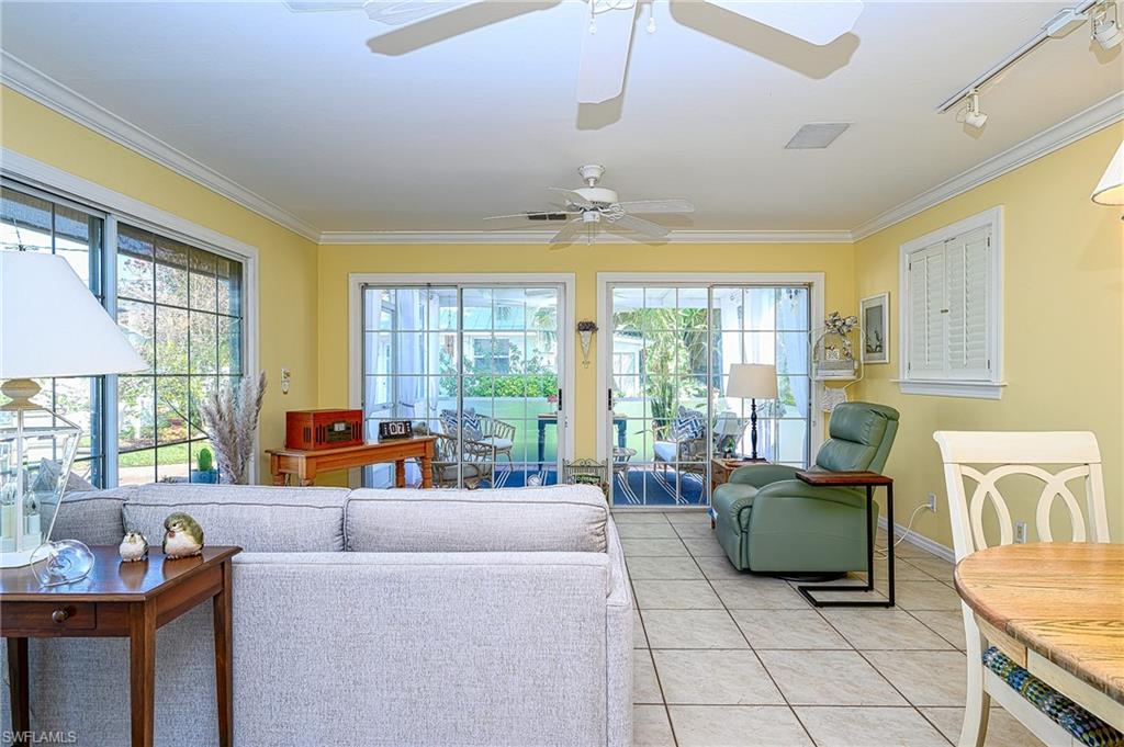 1247 Royal Palm Drive Naples, FL 34103 - Photo 12 of 28 a living room with furniture and a floor to ceiling window