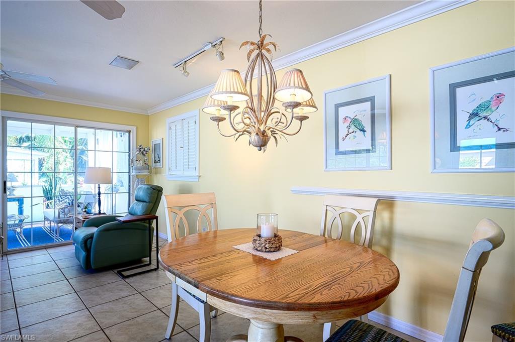 1247 Royal Palm Drive Naples, FL 34103 - Photo 13 of 28 a living room with furniture and a chandelier