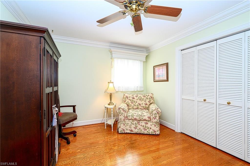 1247 Royal Palm Drive Naples, FL 34103 - Photo 24 of 28 a bedroom with a bed and ceiling fan