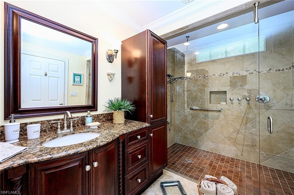 1247 Royal Palm Drive Naples, FL 34103 - Photo 26 of 28 a bathroom with a granite countertop shower sink and mirror