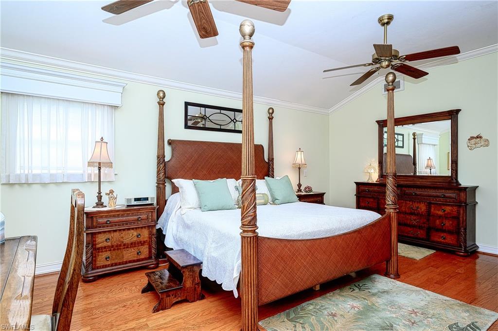 1247 Royal Palm Drive Naples, FL 34103 - Photo 27 of 28 a bedroom with a bed and wooden floor