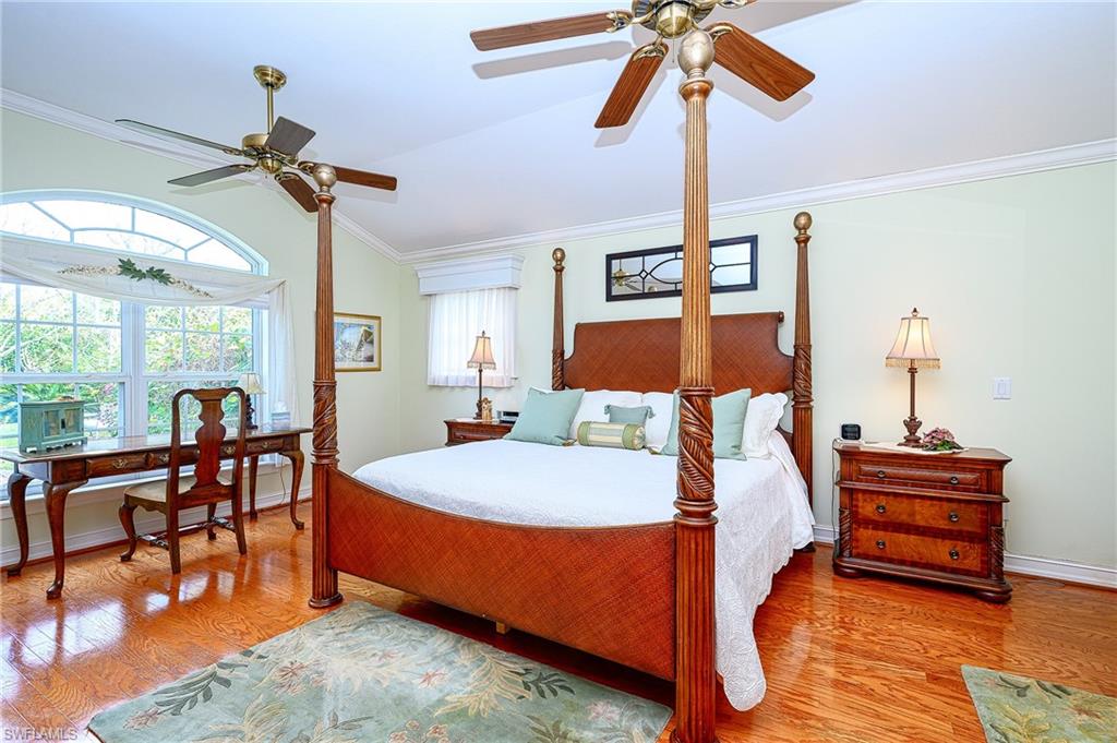 1247 Royal Palm Drive Naples, FL 34103 - Photo 28 of 28 a bed room with a bed and a chandelier