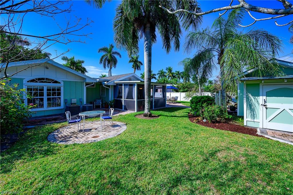 1247 Royal Palm Drive Naples, FL 34103 - Photo 5 of 28 a front view of a house with garden