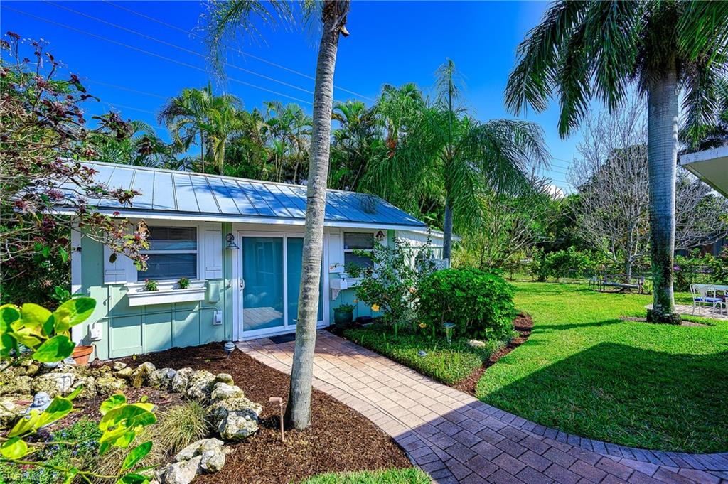 1247 Royal Palm Drive Naples, FL 34103 - Photo 6 of 28 a front view of a house with garden