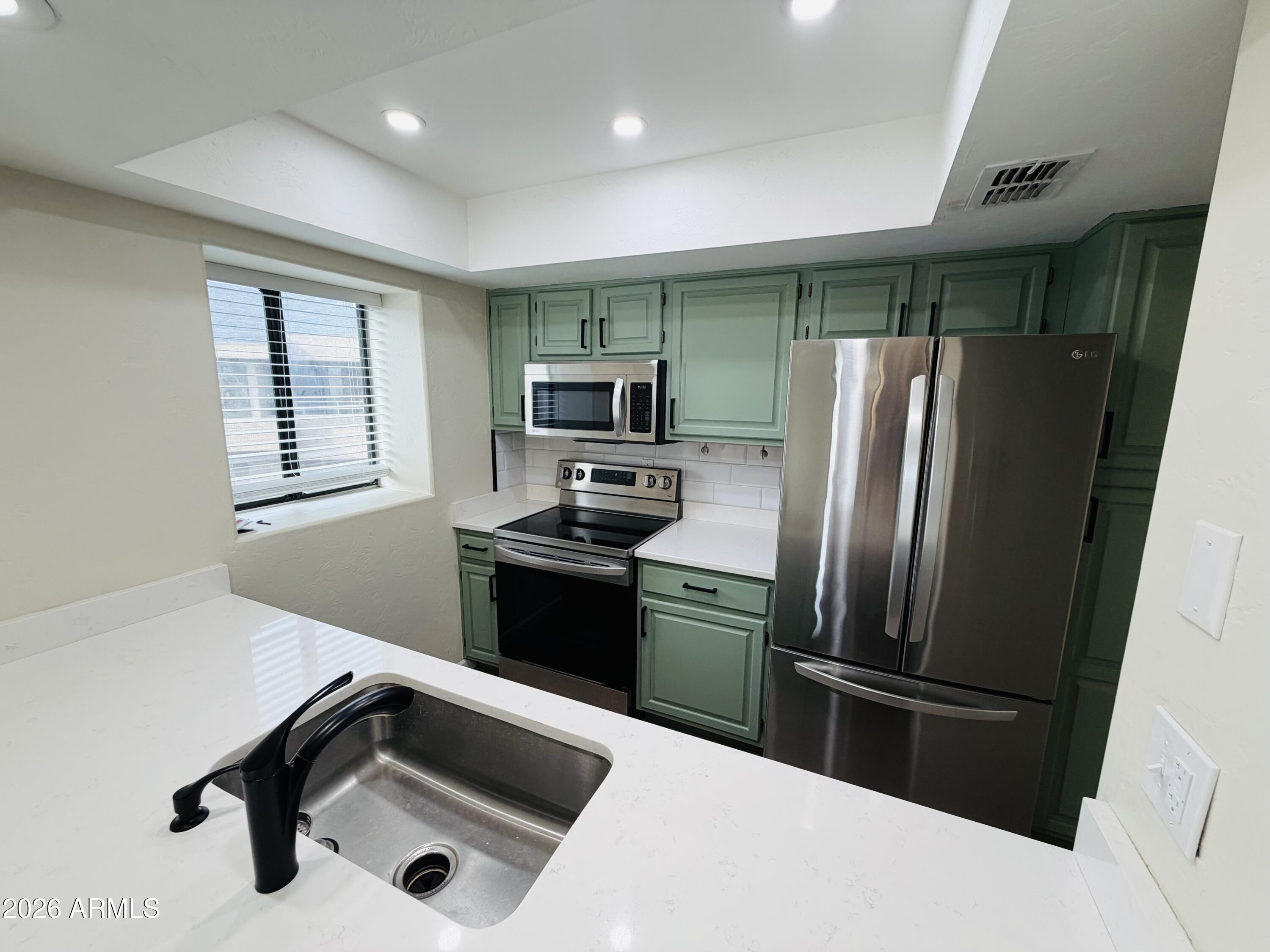 4040 North Weimer Place, Unit 4 Tucson, AZ 85719 - Photo 1 of 12 a kitchen with a refrigerator sink and microwave