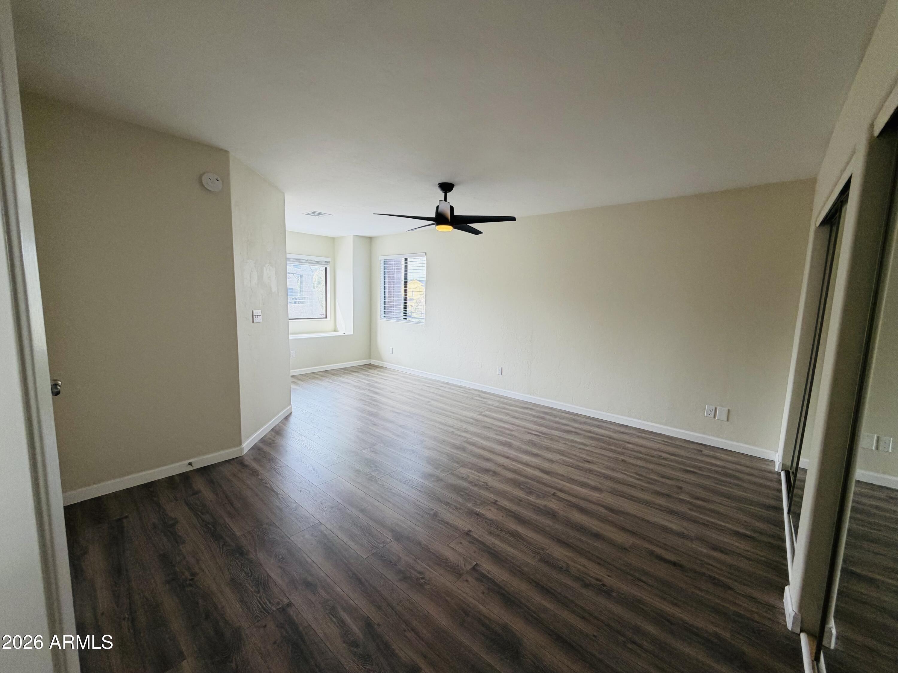 4040 North Weimer Place, Unit 4 Tucson, AZ 85719 - Photo 6 of 12 wooden floor in an empty room with a window