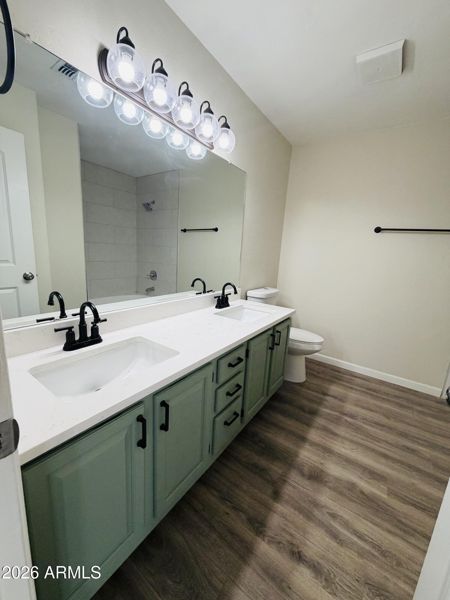 4040 North Weimer Place, Unit 4 Tucson, AZ 85719 - Photo 7 of 12 a bathroom with a double vanity sink and a mirror