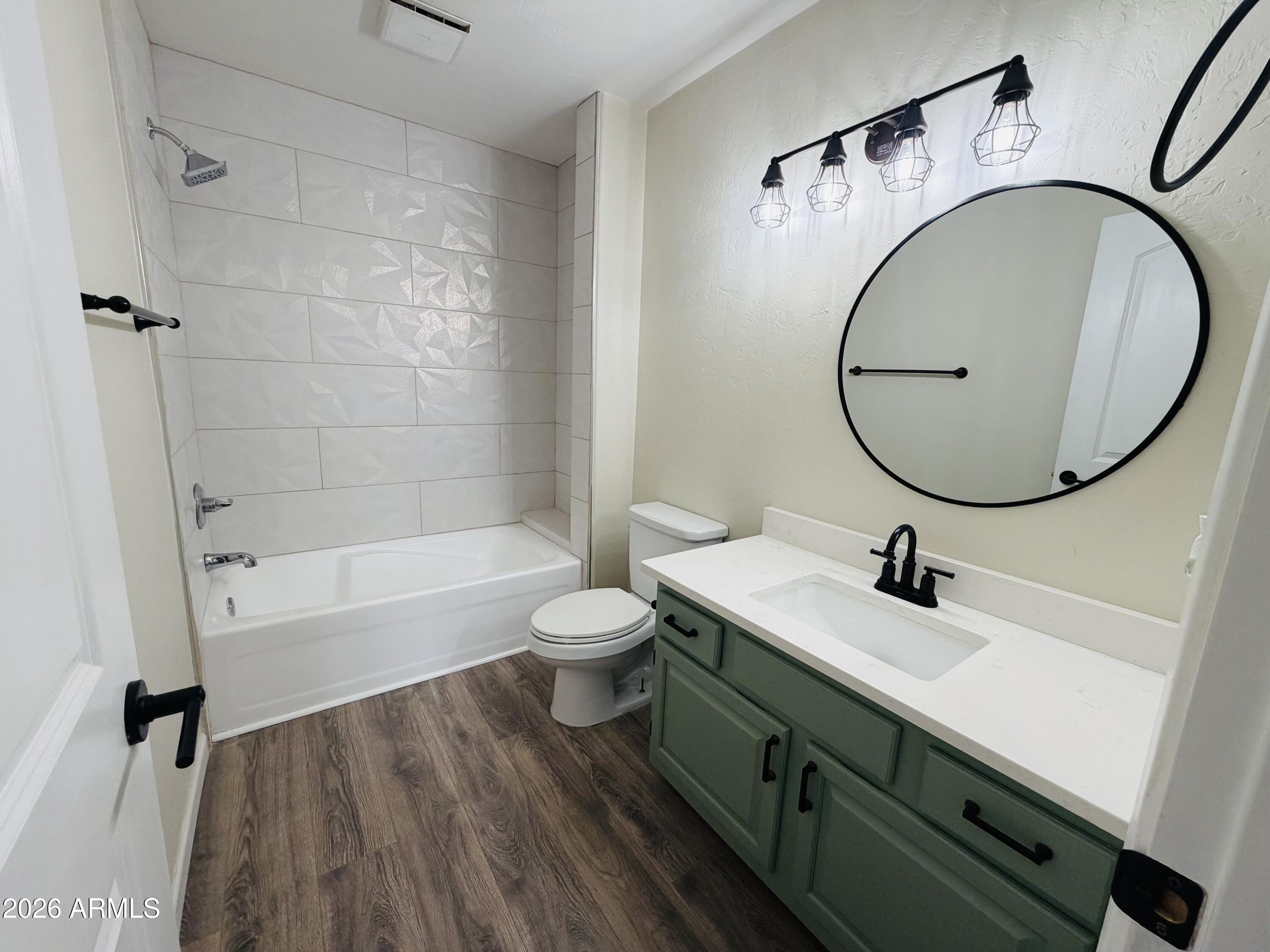 4040 North Weimer Place, Unit 4 Tucson, AZ 85719 - Photo 9 of 12 a bathroom with a sink a toilet and a mirror