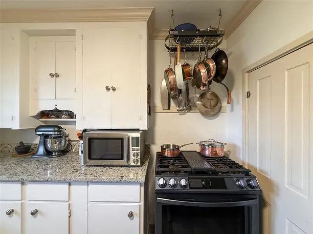 a kitchen with granite countertop stainless steel appliances and a sink