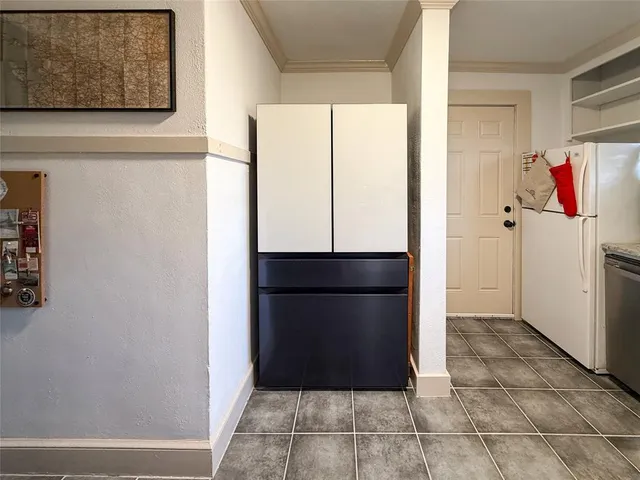 a kitchen with a refrigerator and window