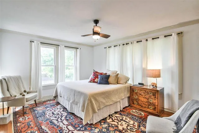 a bedroom with a large bed and a window