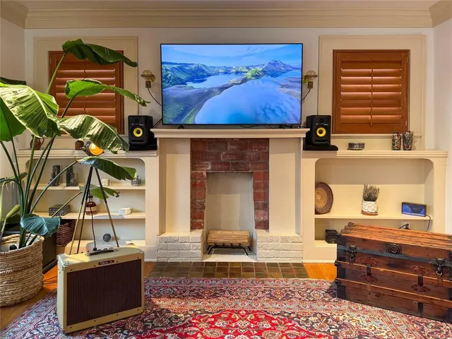 a living room with fireplace furniture and a window