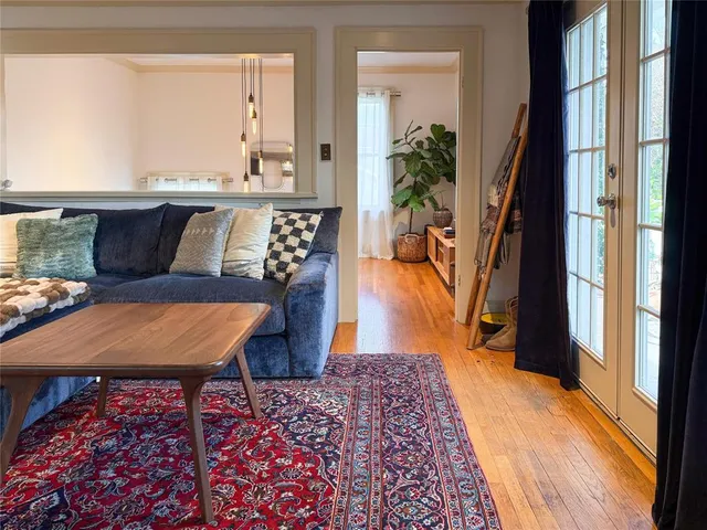 a living room with a rug table and chairs