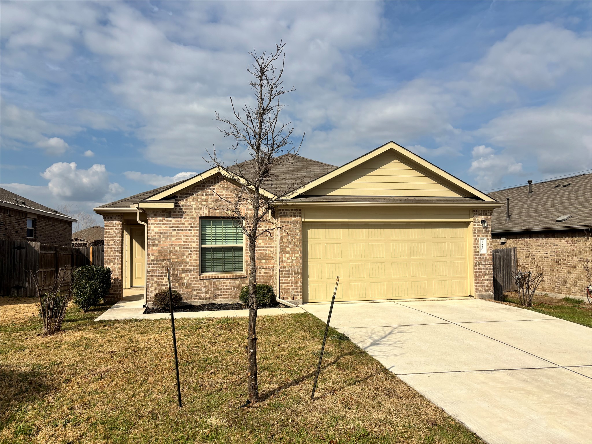 128 Calomel Trail Buda, TX 78610 - Photo 1 of 22 Ranch-style home featuring driveway, brick siding, and a garage