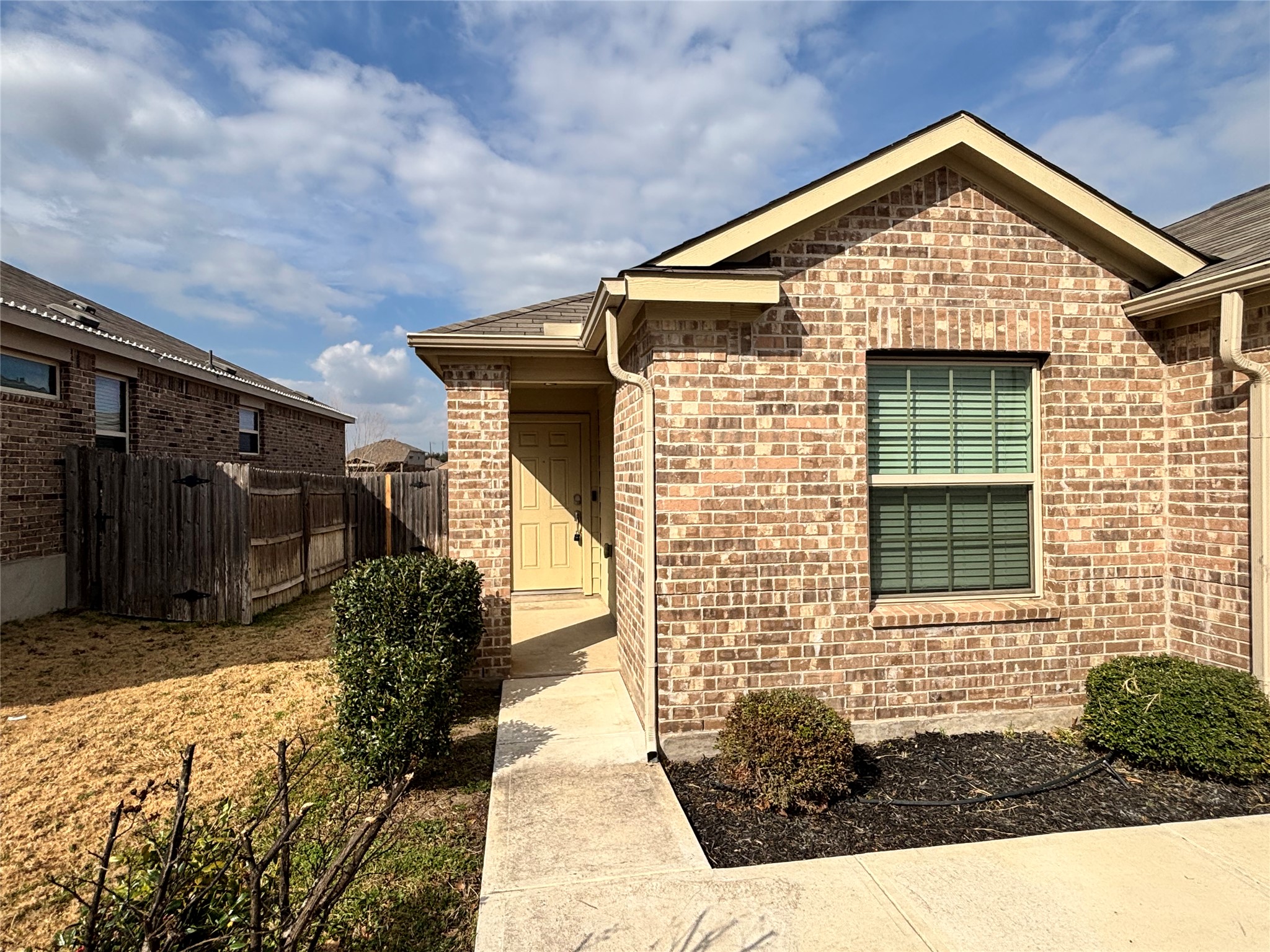 128 Calomel Trail Buda, TX 78610 - Photo 4 of 22 Doorway to property featuring brick siding