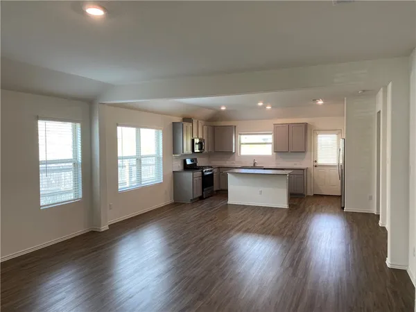 a view of kitchen with wooden floor and windows
