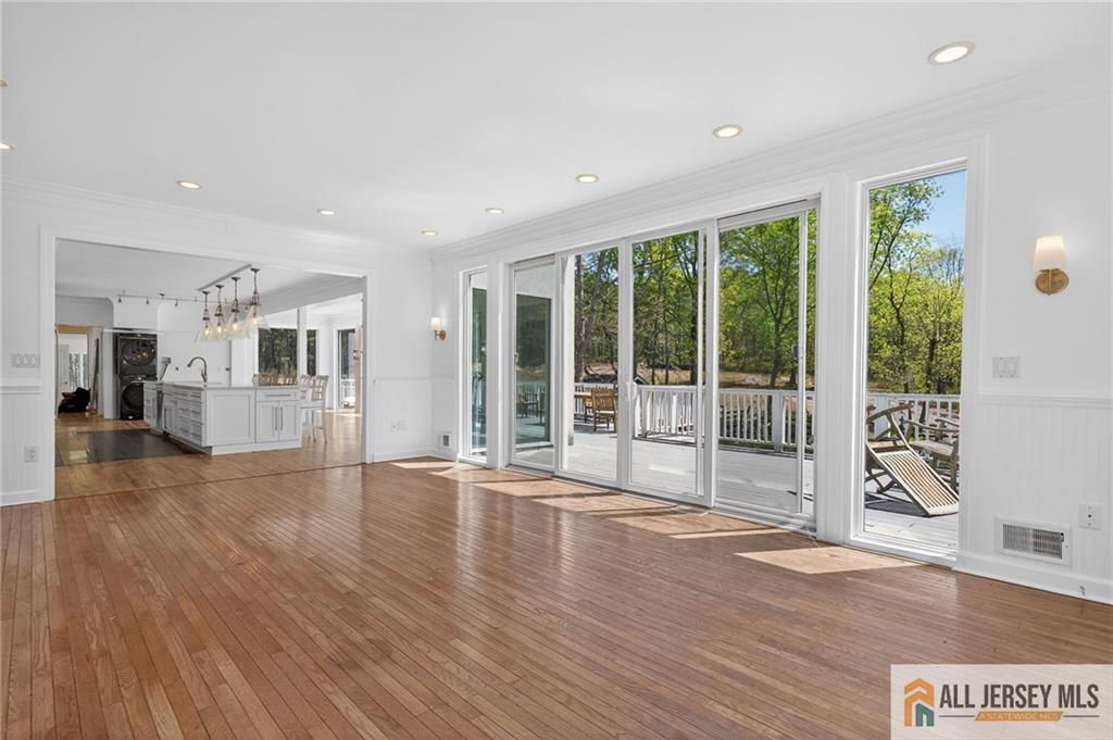 381 Monmouth Road Freehold, NJ 07728 - Photo 42 of 63 a view of empty room with wooden floor and floor to ceiling window