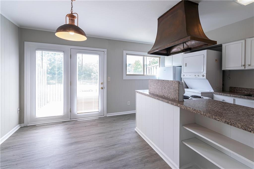 3071 Colonial Way, Unit E Atlanta, GA 30341 - Photo 6 of 16 a kitchen with granite countertop a stove a sink a refrigerator and wooden floor