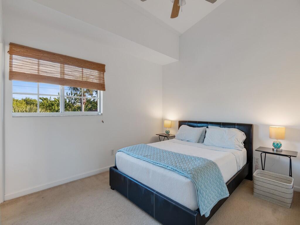 520 7th Square Southwest, Unit 201 Vero Beach, FL 32962 - Photo 14 of 46 a bedroom with a bed and a window