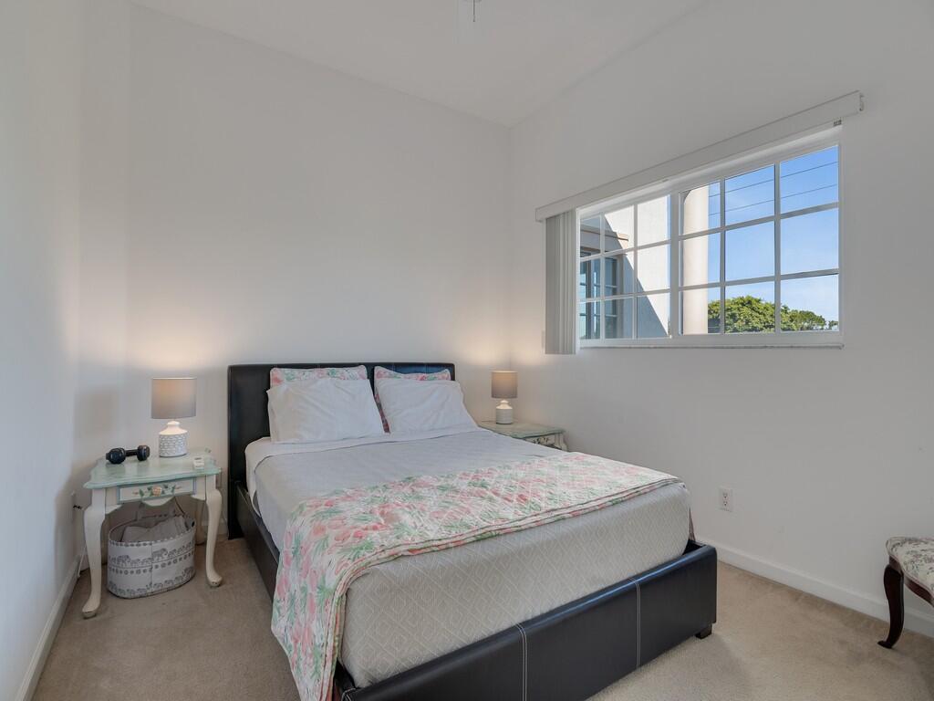 520 7th Square Southwest, Unit 201 Vero Beach, FL 32962 - Photo 17 of 46 a bedroom with a bed and a window