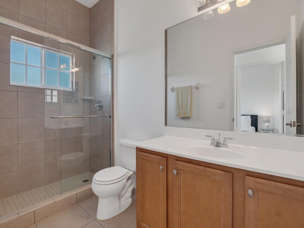 520 7th Square Southwest, Unit 201 Vero Beach, FL 32962 - Photo 18 of 46 a bathroom with a sink a toilet and shower
