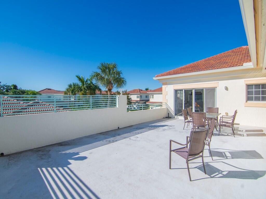 520 7th Square Southwest, Unit 201 Vero Beach, FL 32962 - Photo 21 of 46 a view of a chair and tables in the balcony