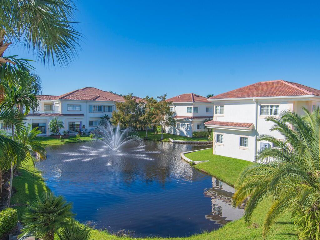 520 7th Square Southwest, Unit 201 Vero Beach, FL 32962 - Photo 22 of 46 a view of a house with a yard and a pond