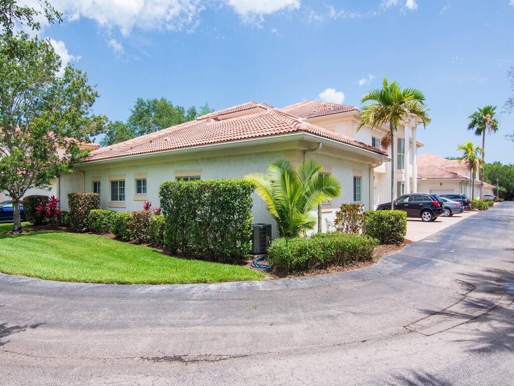 520 7th Square Southwest, Unit 201 Vero Beach, FL 32962 - Photo 27 of 46 a front view of a house with garden