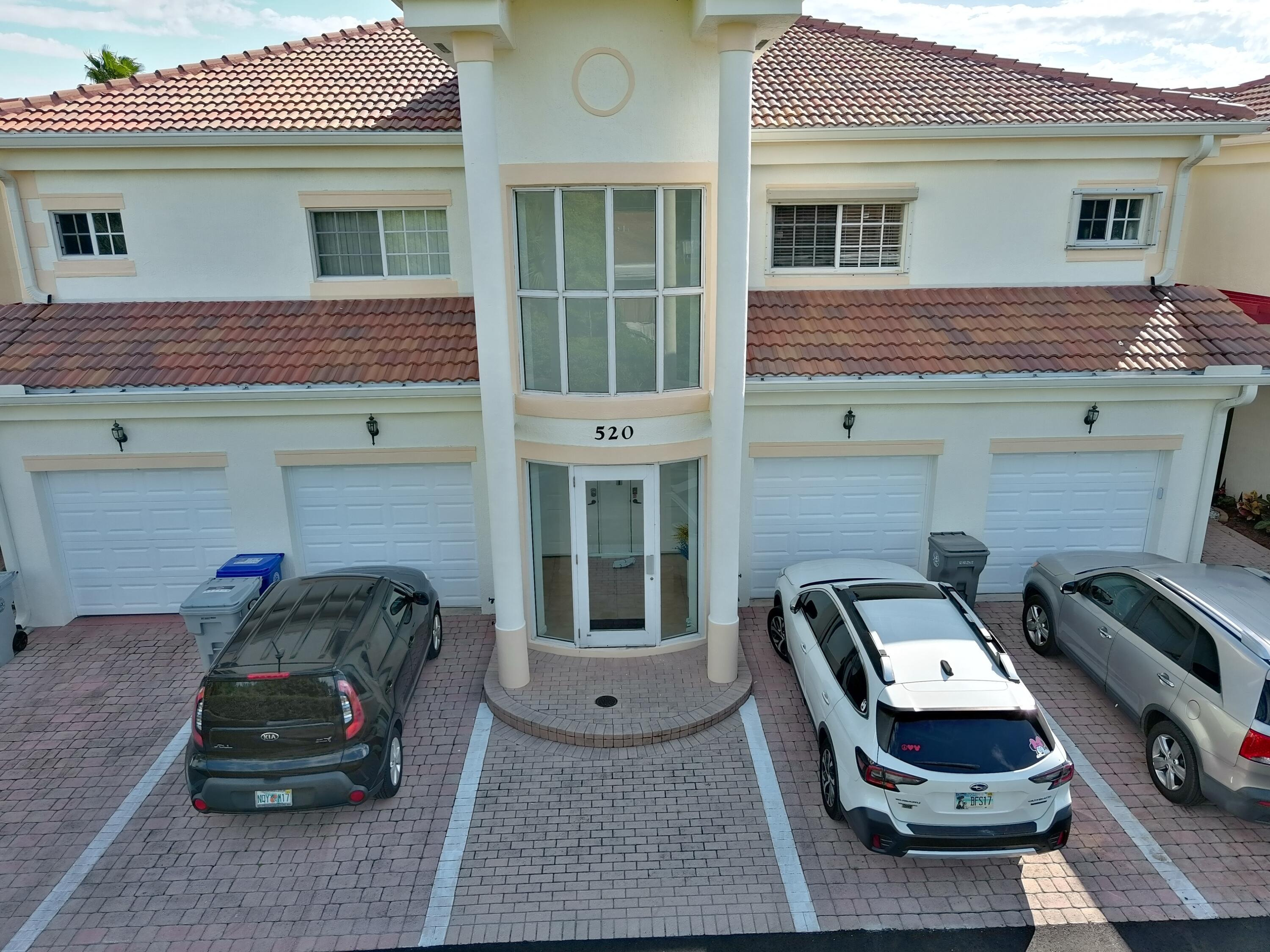 520 7th Square Southwest, Unit 201 Vero Beach, FL 32962 - Photo 41 of 46 a car parked in front of white building