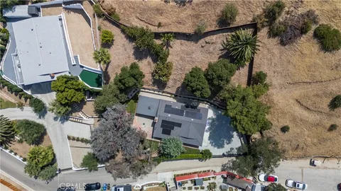 an aerial view of a house with outdoor space