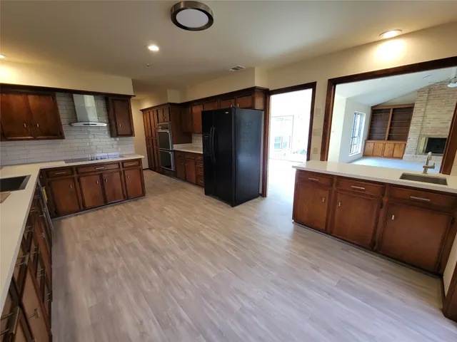 a kitchen with stainless steel appliances granite countertop a refrigerator and a sink