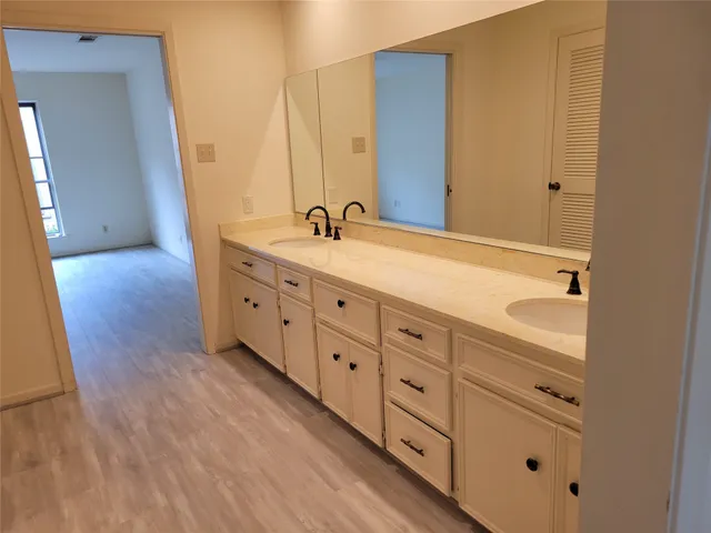 a bathroom with a bathtub sink and vanity