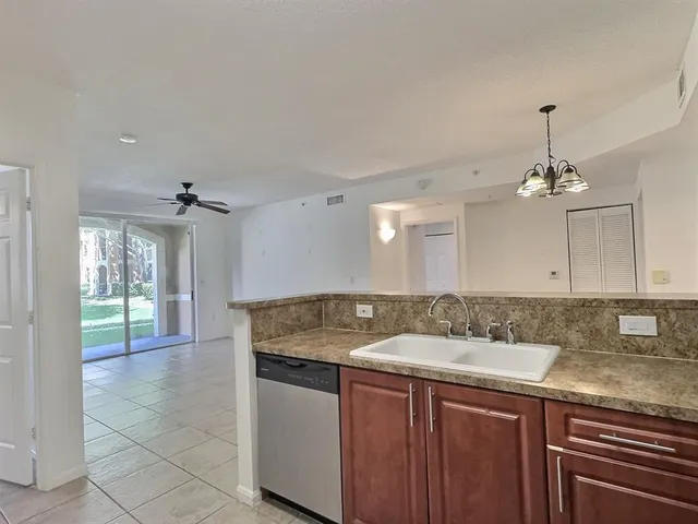 a bathroom with a granite countertop sink a window and a mirror