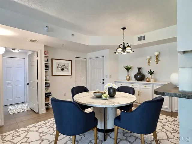 a dining room with furniture and chandelier