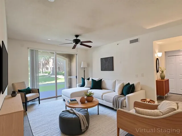 a living room with furniture and a large window
