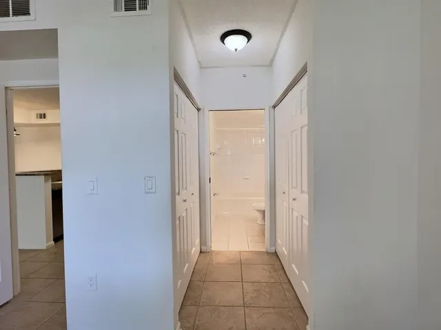 a bathroom with a granite countertop sink toilet a large mirror a shower and a bathtub