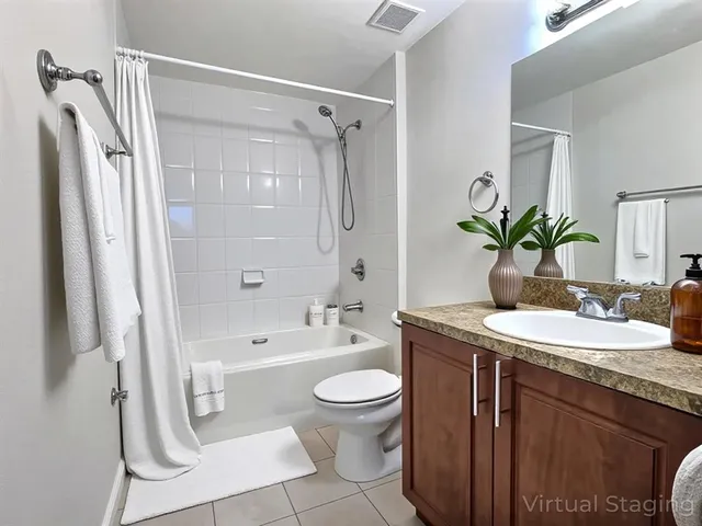 a bathroom with a granite countertop sink a toilet and shower