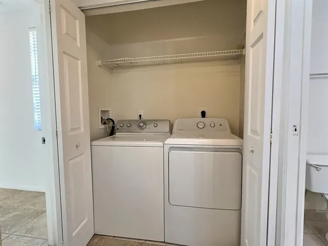 a bathroom with a granite countertop sink mirror and a bathtub