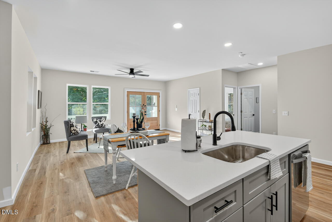 606 North Maple Street Durham, NC 27703 - Photo 22 of 51 a view of kitchen island a sink and living room