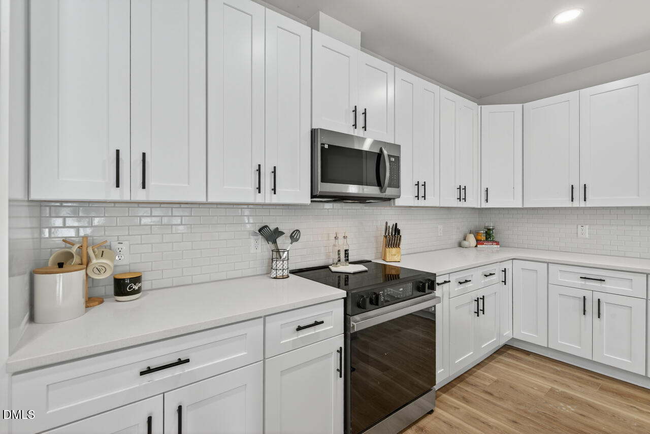 606 North Maple Street Durham, NC 27703 - Photo 23 of 51 a kitchen with white cabinets and white appliances