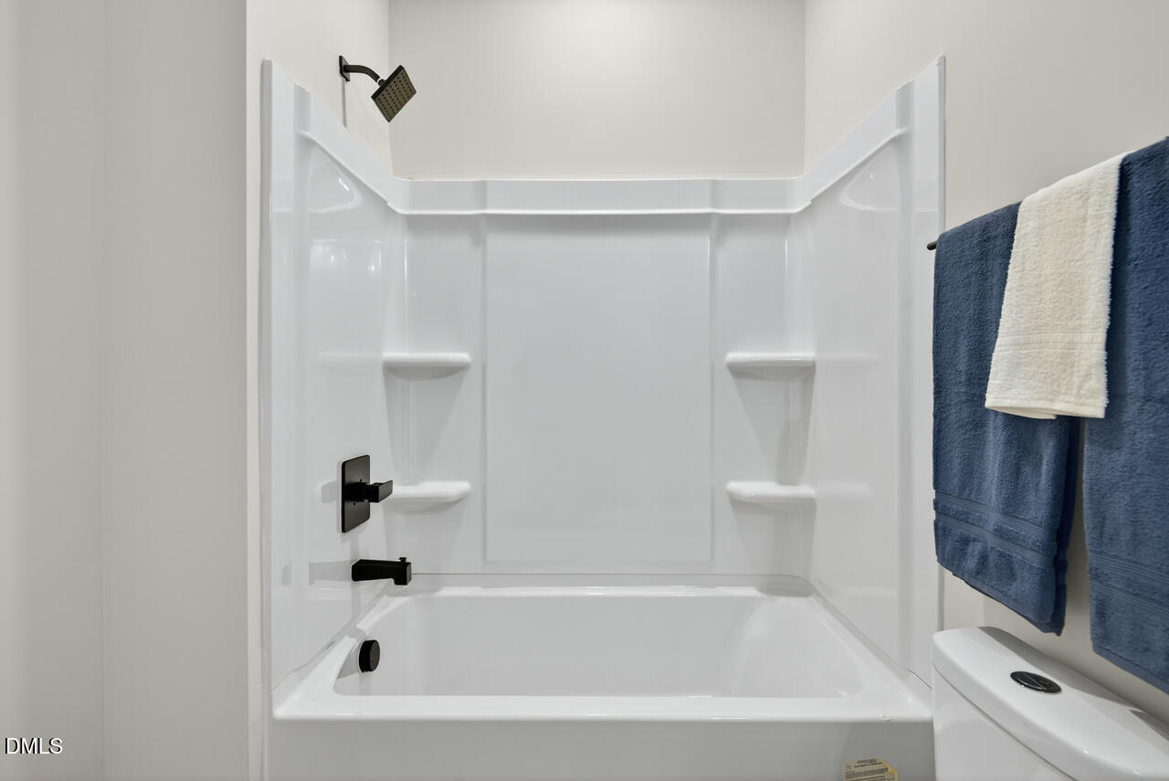 606 North Maple Street Durham, NC 27703 - Photo 27 of 51 a bathroom with a bathtub and a shower