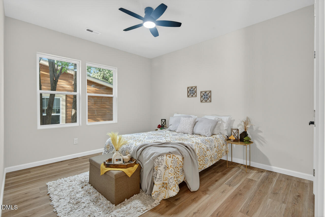 606 North Maple Street Durham, NC 27703 - Photo 29 of 51 a bedroom with a bed and wooden floor