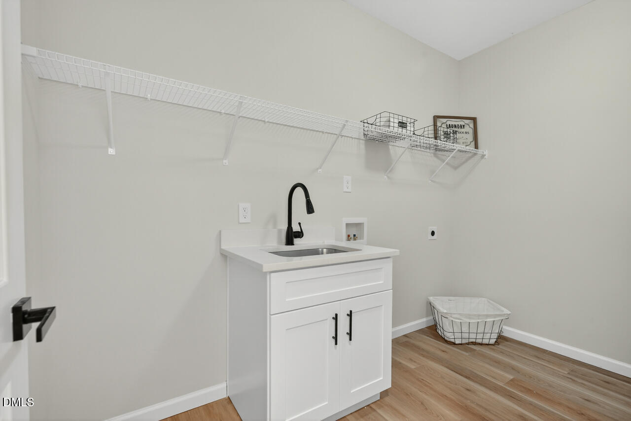 606 North Maple Street Durham, NC 27703 - Photo 31 of 51 a bathroom with a sink and mirror