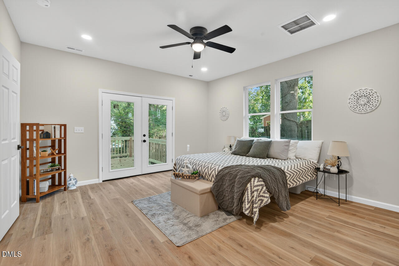 606 North Maple Street Durham, NC 27703 - Photo 33 of 51 a spacious bedroom with a bed and wooden floor