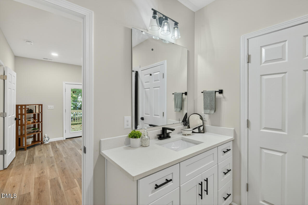606 North Maple Street Durham, NC 27703 - Photo 35 of 51 a bathroom with a sink and a mirror