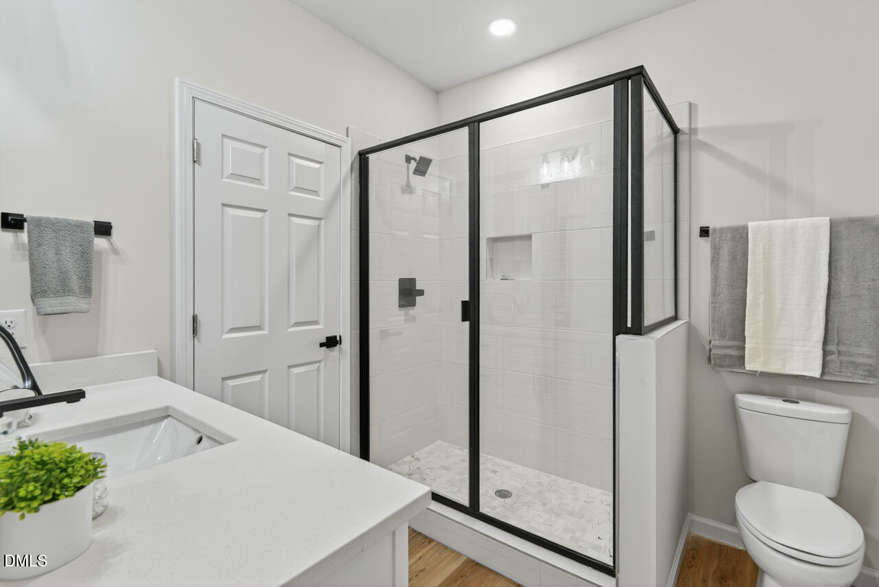 606 North Maple Street Durham, NC 27703 - Photo 6 of 51 a bathroom with a shower toilet and sink